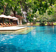 The refreshing outdoor pool is set in manicured gardens