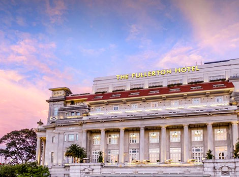 Pink monsoon skies frame The Fullerton Hotel Singapore, one of the best Asian conference hotels