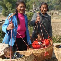 Yangshuo babies hitch a ride in baskets