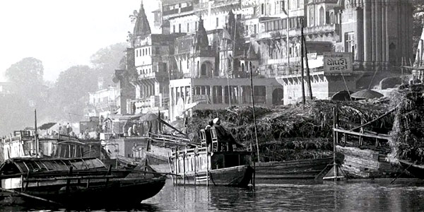 Boats lazily plying the Ganges River, India, at Benares