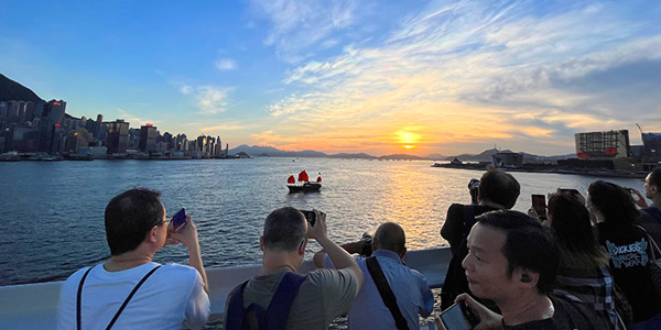 Tourists throng Hong Kong's TST shoreline for a sunset shoot
