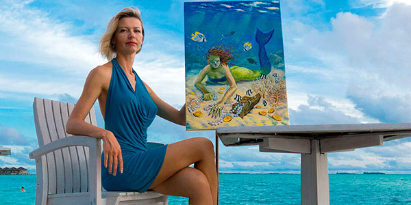 Olga Belka poses with a painting