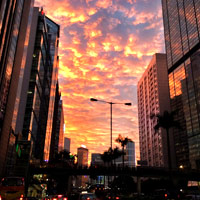 Setting sun sets clouds and buildings ablaze