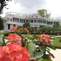 La Residence Hue is a heritage resort with green lawns and a riverside location