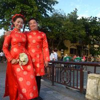 Vietnam beach resorts review, Hoi An couple in red silk pose for the camera